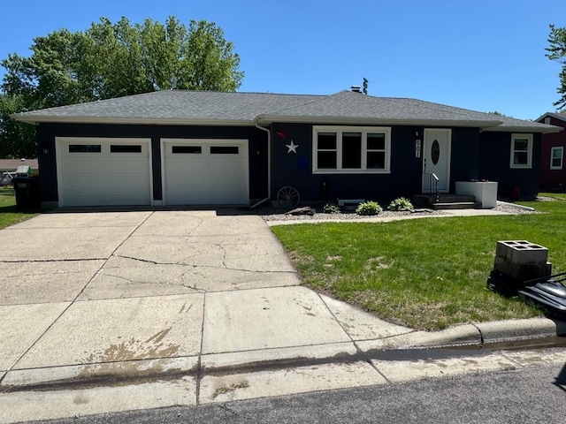 501 3rd St, Olivia, MN 56277 - view of front of house with an attached garage, driveway, a front lawn, and roof with shingles