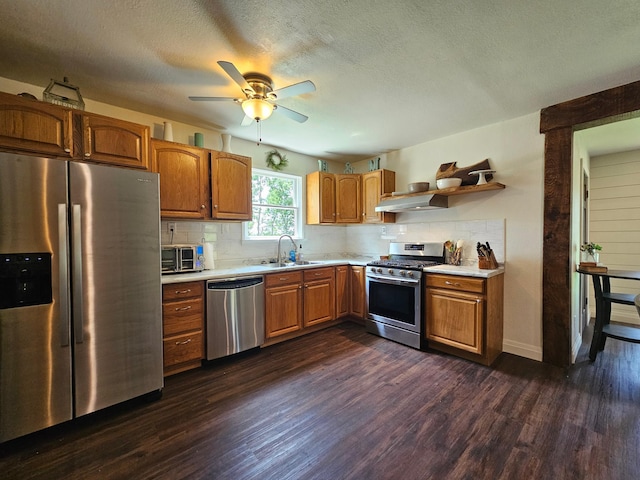 2032 70th Ave, Altona Twp, MN 56164 - kitchen with appliances with stainless steel finishes, light countertops, dark wood-type flooring, decorative backsplash, and a textured ceiling