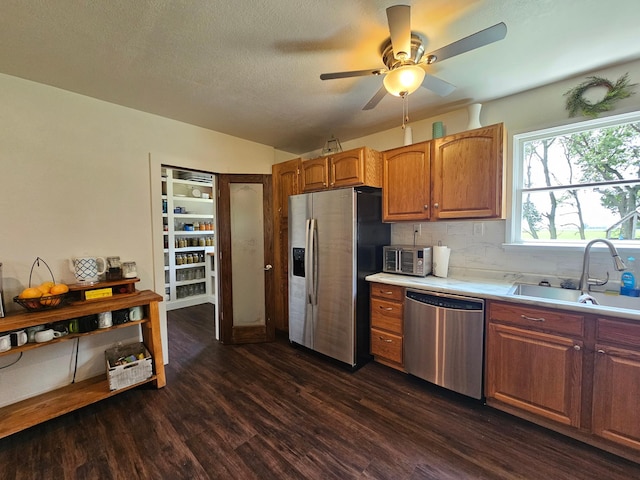 2032 70th Ave, Altona Twp, MN 56164 - kitchen featuring stainless steel appliances, light countertops, dark wood-style flooring, a ceiling fan, and decorative backsplash