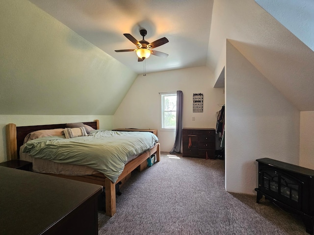 2032 70th Ave, Altona Twp, MN 56164 - carpeted bedroom featuring vaulted ceiling, a wood stove, and a ceiling fan