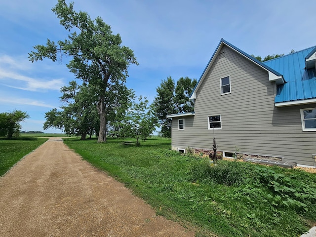 2032 70th Ave, Altona Twp, MN 56164 - view of side of property with a metal roof and a yard