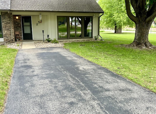 252 Miller St, Spicer, MN 56288 - entrance to property with roof with shingles and a yard