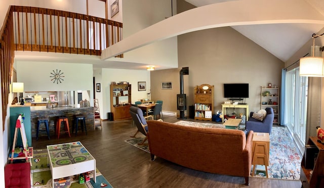 252 Miller St, Spicer, MN 56288 - living room with high vaulted ceiling, wood finished floors, and a baseboard heating unit