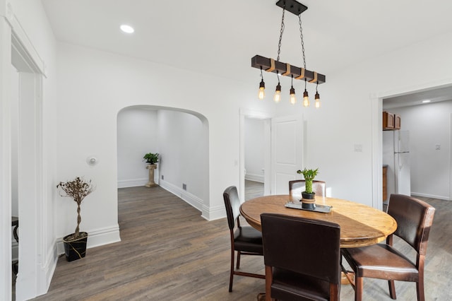 609 2nd Ave NE, Sleepy Eye, MN 56085 - dining space with arched walkways, dark wood-style flooring, baseboards, and recessed lighting