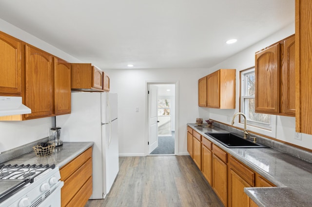 609 2nd Ave NE, Sleepy Eye, MN 56085 - kitchen featuring a sink, ventilation hood, light wood-style flooring, white appliances, and recessed lighting