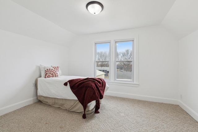 609 2nd Ave NE, Sleepy Eye, MN 56085 - carpeted bedroom with vaulted ceiling and baseboards