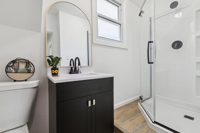 609 2nd Ave NE, Sleepy Eye, MN 56085 - full bath featuring a stall shower, vanity, toilet, wood finished floors, and baseboards