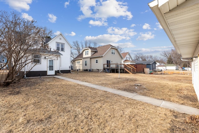 609 2nd Ave NE, Sleepy Eye, MN 56085 - rear view of house featuring a wooden deck, a residential view, and stairs