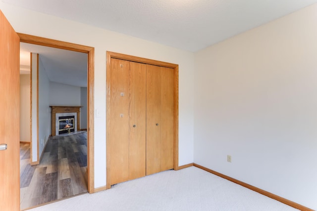 11622 Rio Loma Ln, Burnsville, MN 55337 - unfurnished bedroom with baseboards, a glass covered fireplace, and a closet