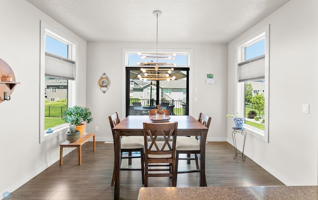 3784 Bell Blvd E, West Fargo, ND 58078 - dining area featuring plenty of natural light, dark wood finished floors, a chandelier, and baseboards