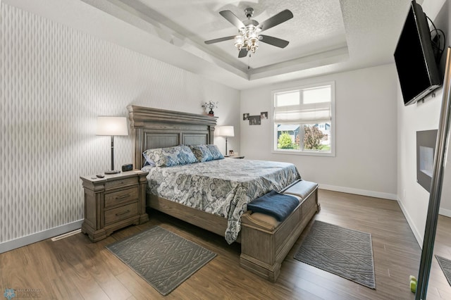 3784 Bell Blvd E, West Fargo, ND 58078 - bedroom featuring baseboards, a tray ceiling, and dark wood-style floors