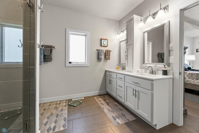 3784 Bell Blvd E, West Fargo, ND 58078 - full bath featuring double vanity, ensuite bathroom, baseboards, tile patterned floors, and a shower