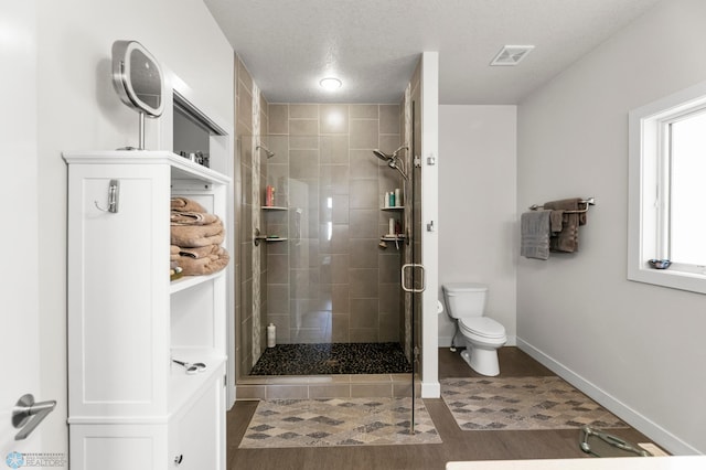 3784 Bell Blvd E, West Fargo, ND 58078 - bathroom with a stall shower, toilet, baseboards, and wood finished floors