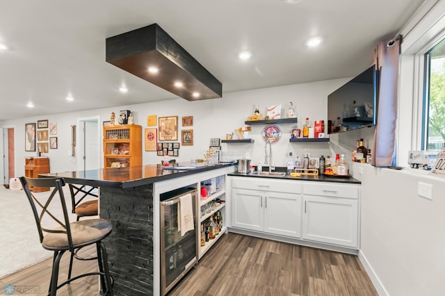 3784 Bell Blvd E, West Fargo, ND 58078 - kitchen with a sink, dark countertops, open shelves, beverage cooler, and dark wood finished floors