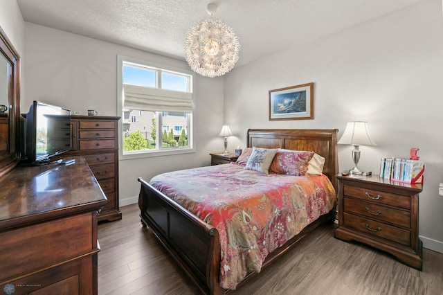 3784 Bell Blvd E, West Fargo, ND 58078 - bedroom with baseboards, wood finished floors, and a chandelier