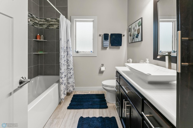 3784 Bell Blvd E, West Fargo, ND 58078 - full bathroom featuring vanity, toilet, baseboards, shower / bath combo with shower curtain, and wood finished floors