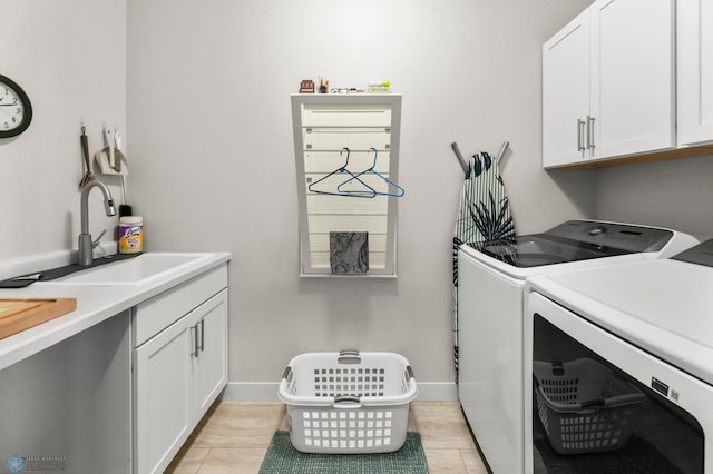 3784 Bell Blvd E, West Fargo, ND 58078 - washroom with washing machine and clothes dryer, cabinet space, light tile patterned floors, and baseboards