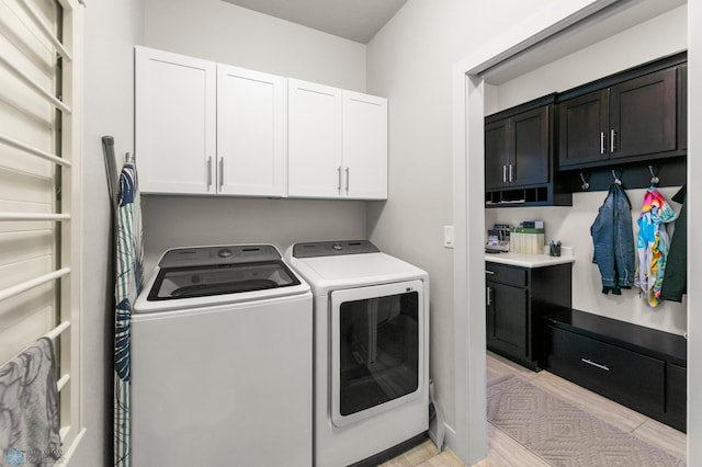3784 Bell Blvd E, West Fargo, ND 58078 - laundry room featuring washer and dryer, cabinet space, and light wood finished floors