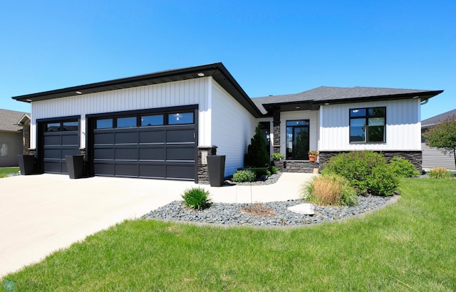 3784 Bell Blvd E, West Fargo, ND 58078 - view of front facade featuring stone siding, driveway, a front yard, and an attached garage