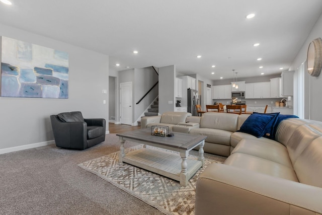 12905 Jewell Cir NE, Blaine, MN 55449 - living area featuring recessed lighting, stairway, baseboards, and light carpet
