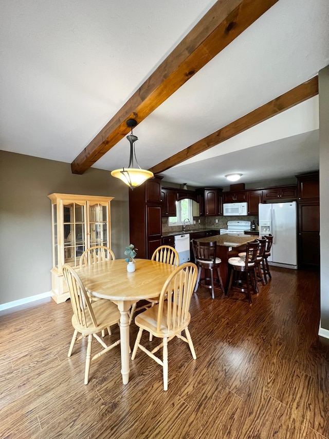 17300 Baseline Ave, Sand Creek Twp, MN 55352 - dining room with dark wood-type flooring, beam ceiling, and baseboards