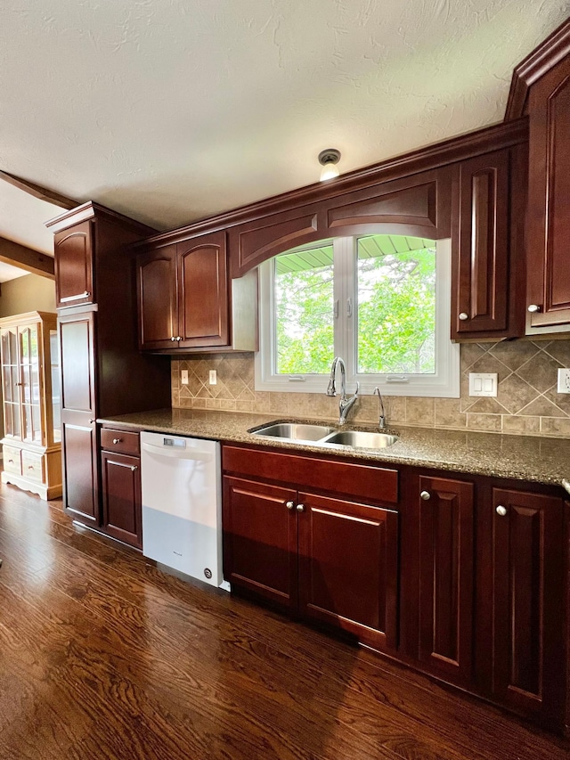 17300 Baseline Ave, Sand Creek Twp, MN 55352 - kitchen with dishwasher, a sink, dark wood-type flooring, and backsplash