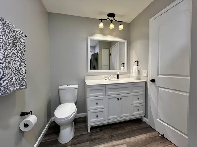 17300 Baseline Ave, Sand Creek Twp, MN 55352 - full bathroom with vanity, toilet, wood finished floors, and baseboards