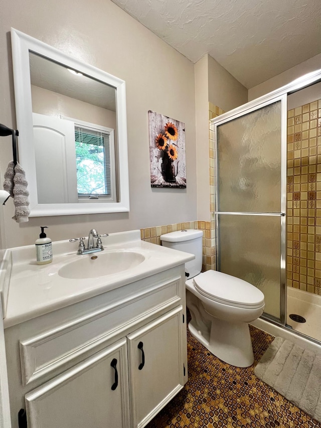 17300 Baseline Ave, Sand Creek Twp, MN 55352 - bathroom featuring vanity, toilet, a shower stall, and tile walls