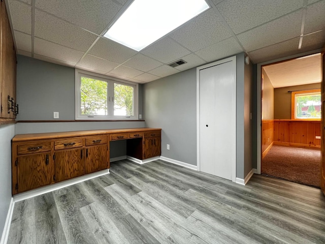 17300 Baseline Ave, Sand Creek Twp, MN 55352 - unfurnished office featuring a paneled ceiling, wood finished floors, built in study area, and baseboards