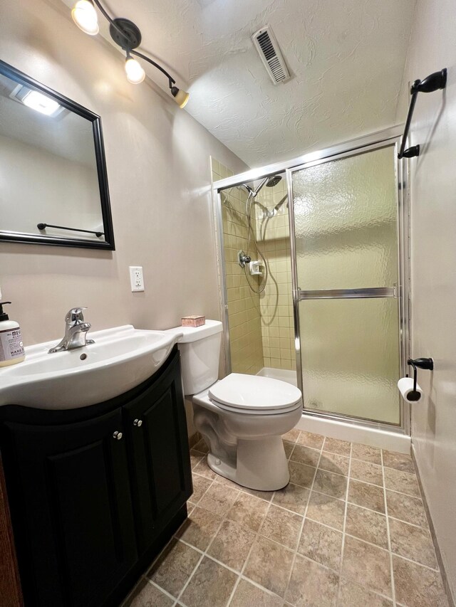 17300 Baseline Ave, Sand Creek Twp, MN 55352 - full bathroom featuring vanity, a shower stall, toilet, and a textured ceiling