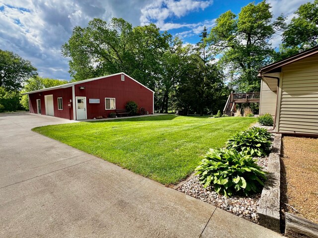 17300 Baseline Ave, Sand Creek Twp, MN 55352 - view of grassy yard with stairs, an outbuilding, and a deck