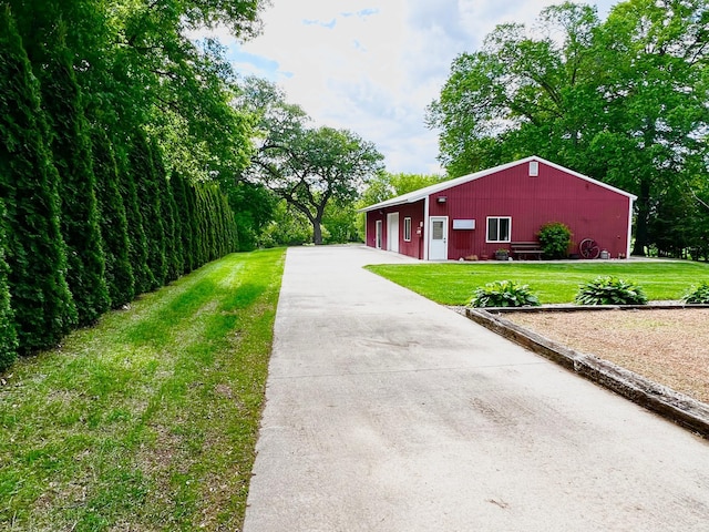 17300 Baseline Ave, Sand Creek Twp, MN 55352 - view of side of home featuring a detached garage, a lawn, a pole building, and an outbuilding