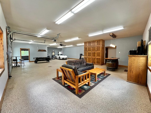 17300 Baseline Ave, Sand Creek Twp, MN 55352 - living area with baseboards, billiards table, a ceiling fan, and a garage