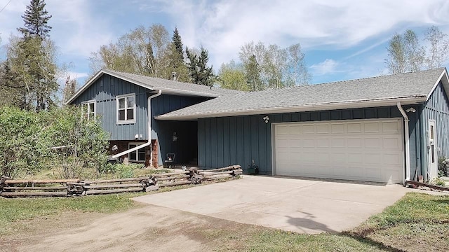 7470 Point Ln, Britt, MN 55710 - split level home featuring concrete driveway, a shingled roof, an attached garage, and board and batten siding