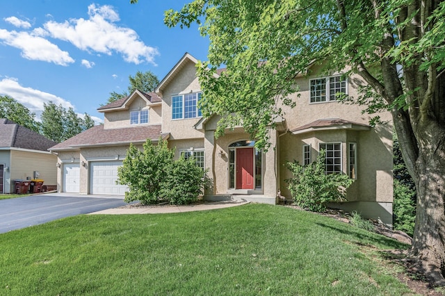 505 Chapel Ct, Eagan, MN 55121 - view of front of property with driveway, stucco siding, a front yard, and a garage