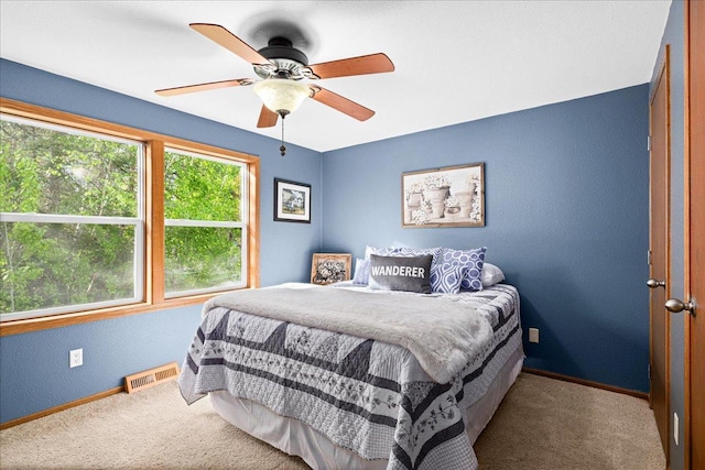 2614 Leroy Rd, Eveleth, MN 55734 - carpeted bedroom with baseboards, a textured wall, and ceiling fan