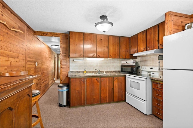 2614 Leroy Rd, Eveleth, MN 55734 - kitchen with white appliances, under cabinet range hood, a sink, brown cabinetry, and dark countertops