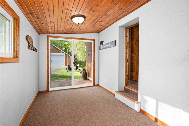 2614 Leroy Rd, Eveleth, MN 55734 - doorway featuring carpet floors, baseboards, wood ceiling, vaulted ceiling, and a textured wall