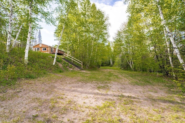 2614 Leroy Rd, Eveleth, MN 55734 - view of yard with stairs, a deck, and a wooded view