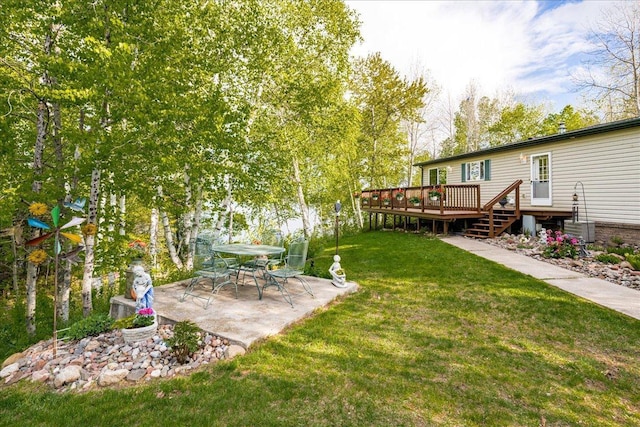2614 Leroy Rd, Eveleth, MN 55734 - view of grassy yard with a wooden deck and a patio