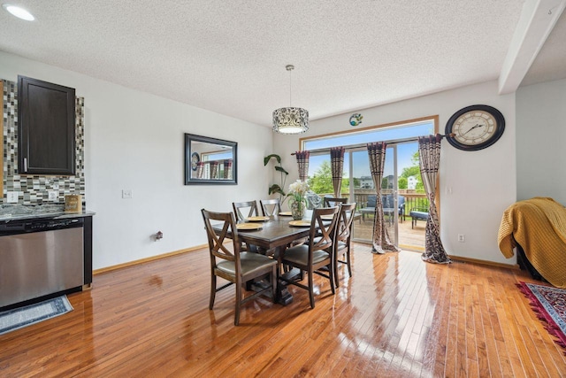 12332 3rd St NE, Blaine, MN 55434 - dining space featuring light wood-style flooring, a textured ceiling, and baseboards