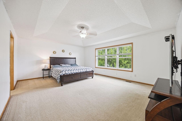 12332 3rd St NE, Blaine, MN 55434 - carpeted bedroom featuring a raised ceiling, baseboards, a textured ceiling, and ceiling fan