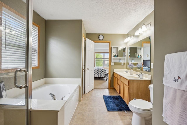 12332 3rd St NE, Blaine, MN 55434 - full bathroom with vanity, a bath, a textured ceiling, and toilet