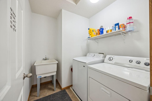12332 3rd St NE, Blaine, MN 55434 - laundry room featuring washing machine and dryer, a textured ceiling, and baseboards