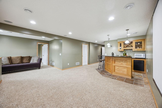 12332 3rd St NE, Blaine, MN 55434 - kitchen with white microwave, light carpet, recessed lighting, baseboards, and glass insert cabinets