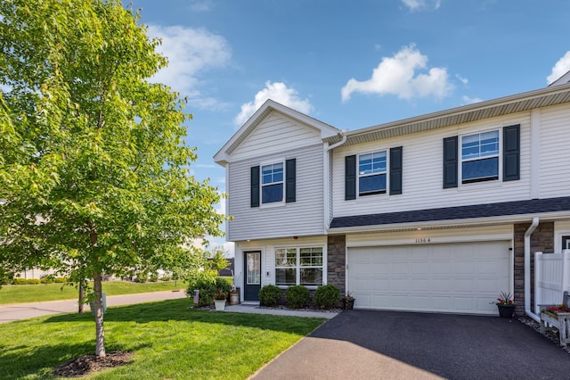 11564 Woodside Dr, Rogers, MN 55311 - view of property with driveway, a front yard, stone siding, and a garage