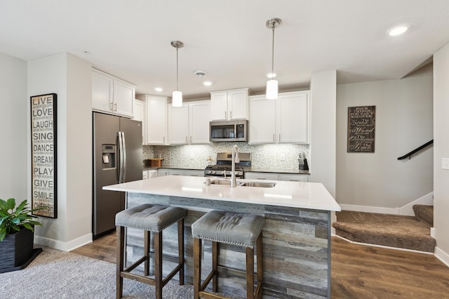 11564 Woodside Dr, Rogers, MN 55311 - kitchen featuring stainless steel appliances, baseboards, tasteful backsplash, white cabinets, and a sink