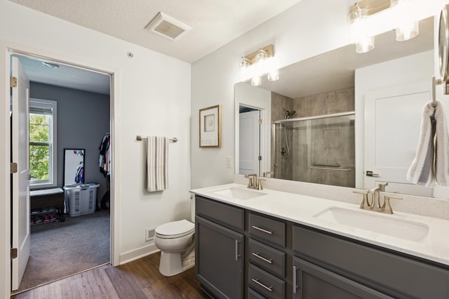 11564 Woodside Dr, Rogers, MN 55311 - full bath with a stall shower, toilet, double vanity, wood finished floors, and baseboards