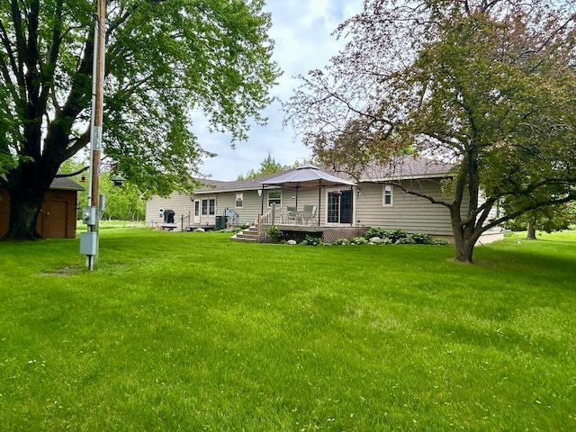 10696 Leaf River Rd, Leaf River Twp, MN 56482 - back of property featuring a lawn and a wooden deck