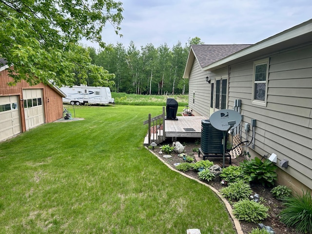 10696 Leaf River Rd, Leaf River Twp, MN 56482 - view of green lawn featuring a wooden deck, an outdoor structure, and a detached garage